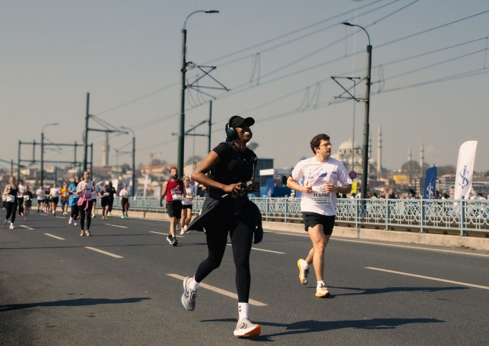 Runner stretching knee outdoors on a bright path