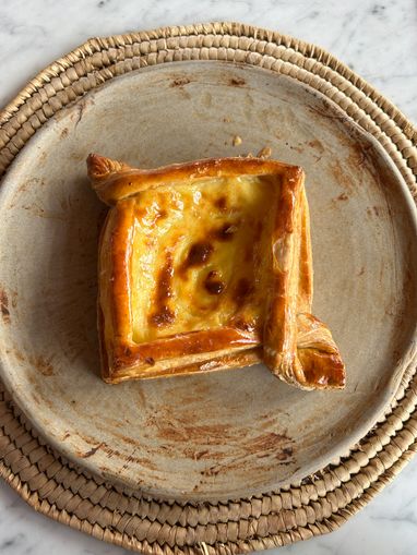 Glazed custard pastry on a stoneware plate — photo by new perspectives on Pexels