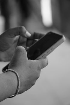 A person uses a smartphone outdoors, capturing the essence of connection and modern technology.