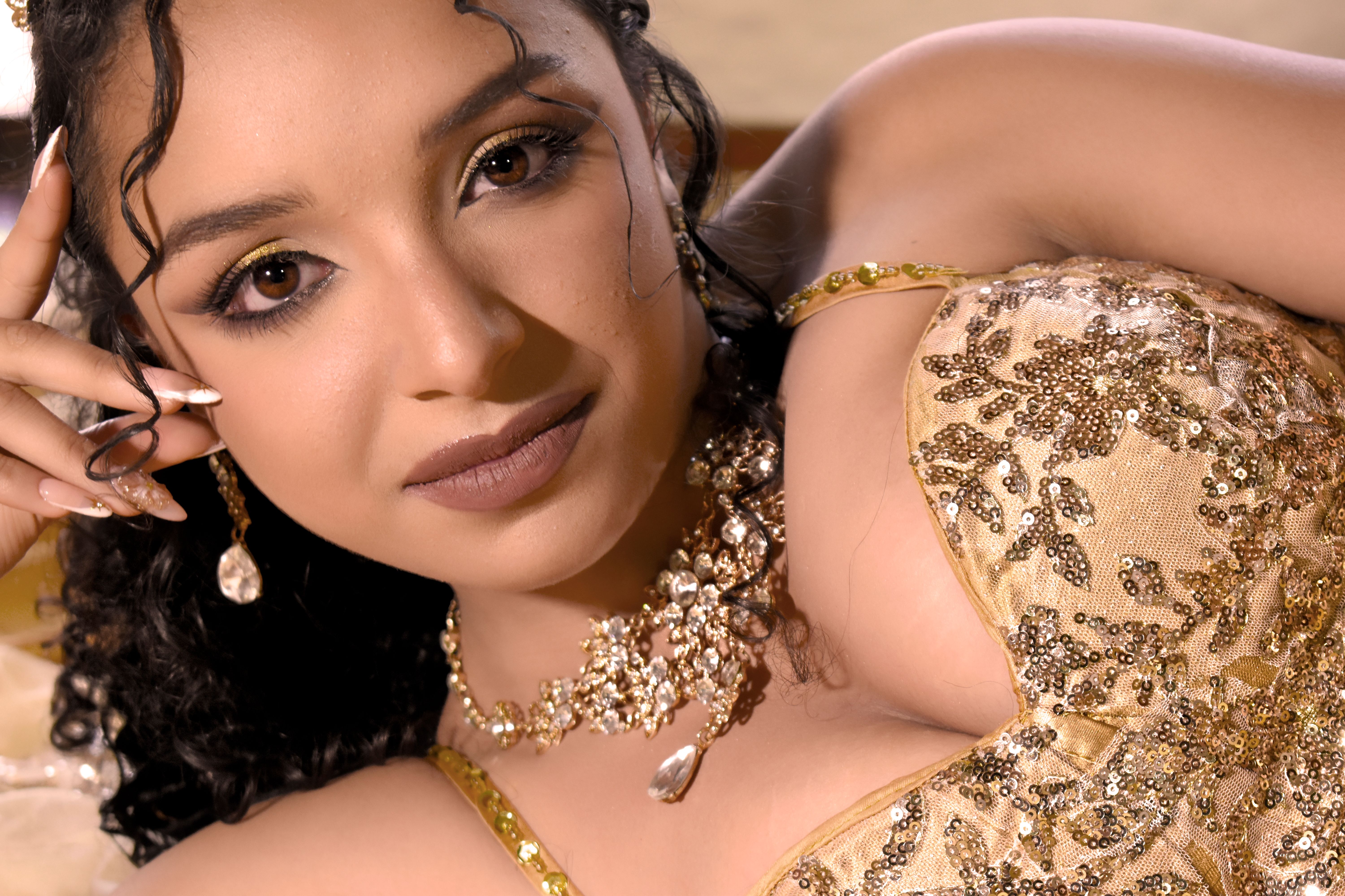 Elegant Woman in Gold Embellished Gown Portrait