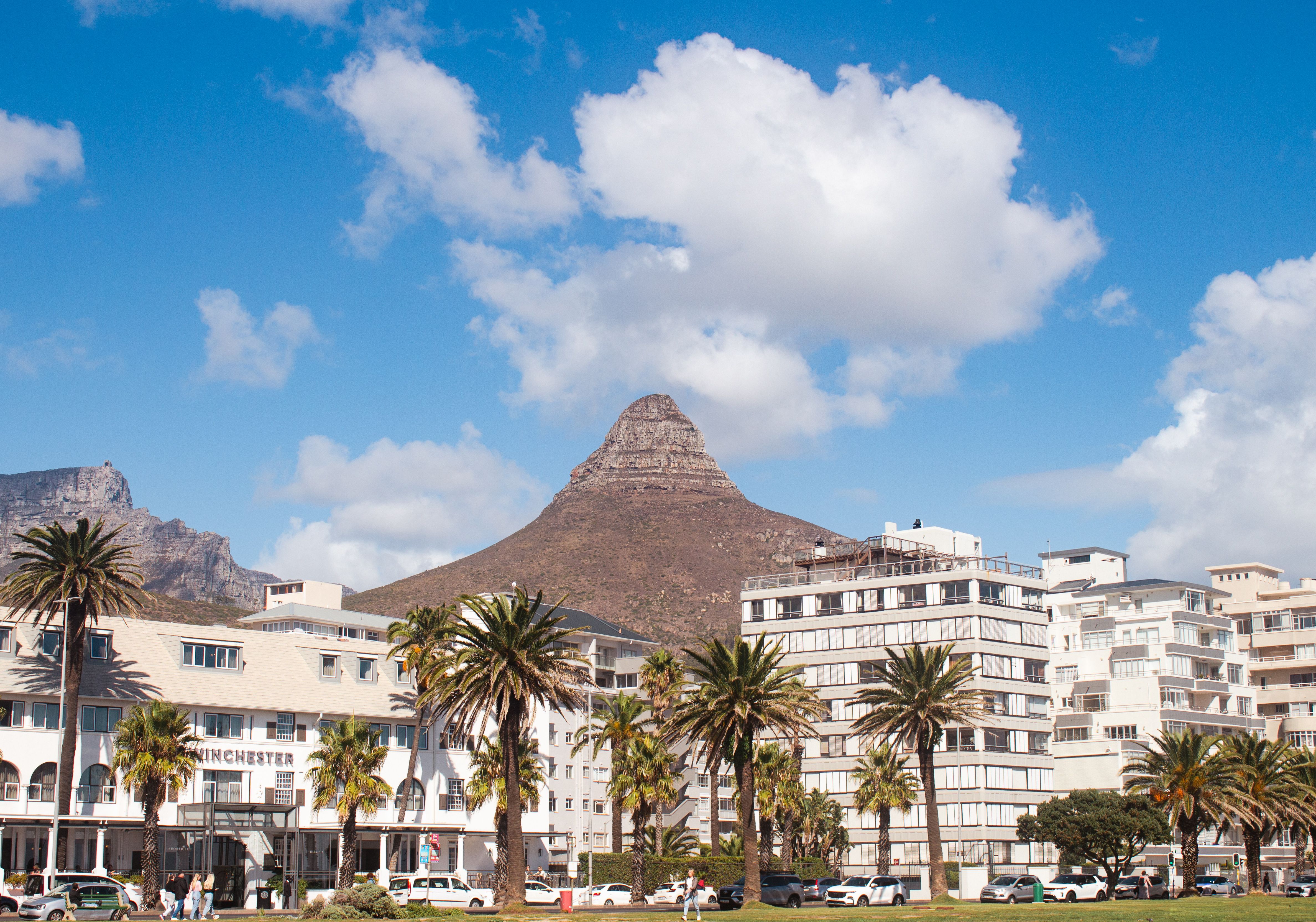 The paved seafront promenade between Sea Point and Mouille Point with apartment blocks on one side and Atlantic surf on the other