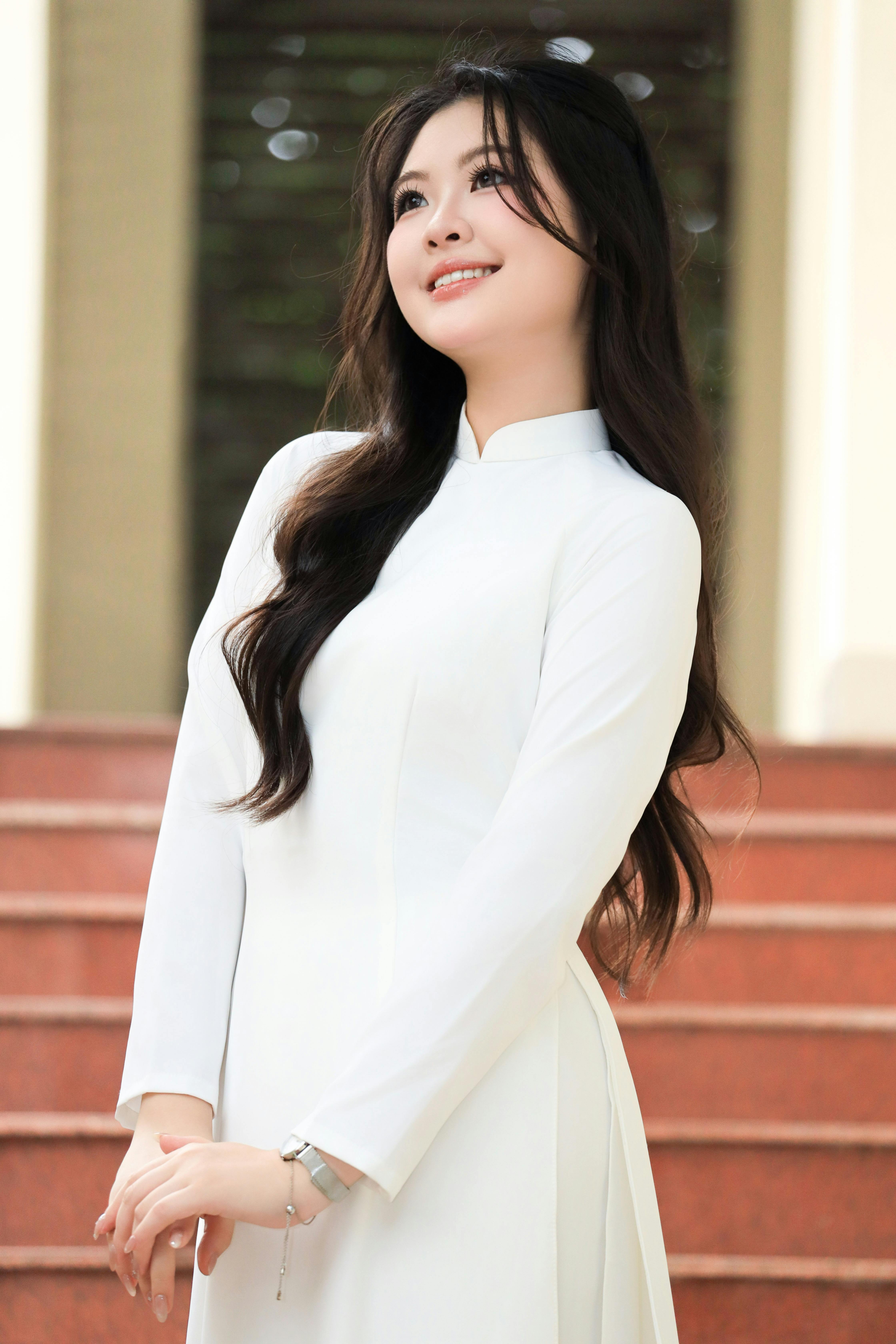 Elegant portrait of a young woman wearing a traditional white Áo Dài in Vietnam.