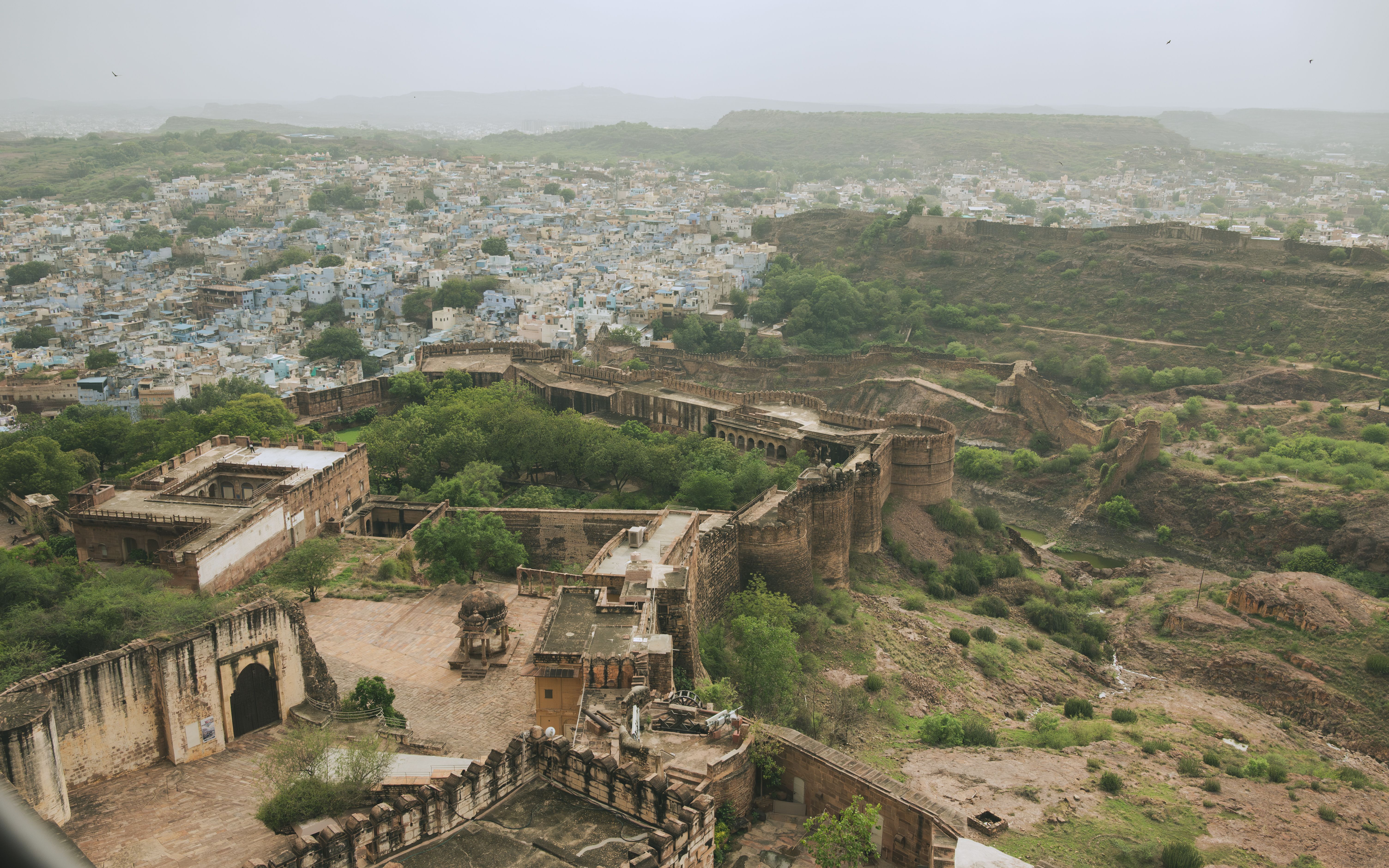 Terraced ramparts of Neemrana Fort-Palace stacked against an Aravalli hillside at dusk