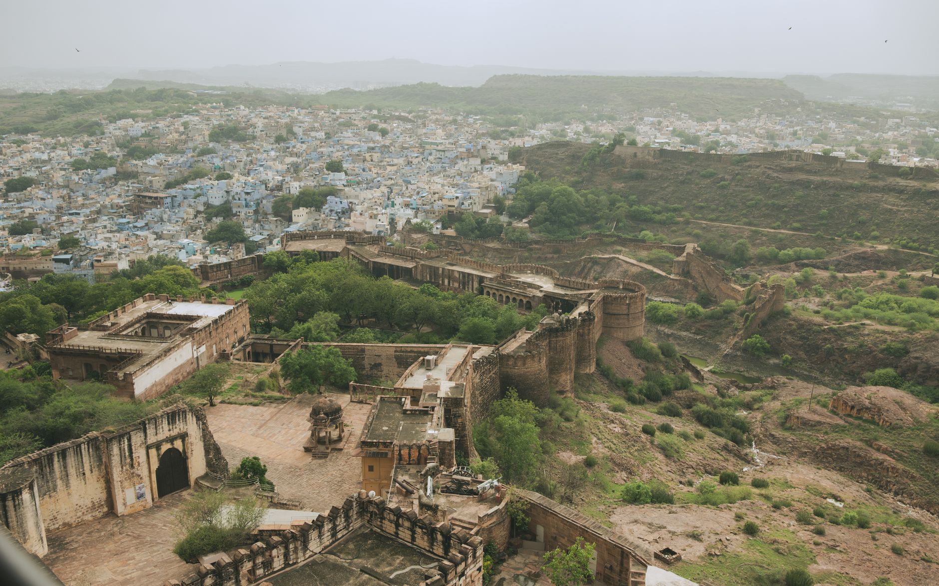 Terraced ramparts of Neemrana Fort-Palace stacked against an Aravalli hillside at dusk