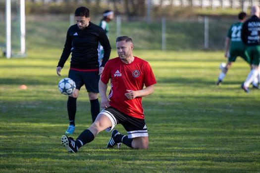 Amateur soccer players in action during a friendly match in Jönköping, Sweden.