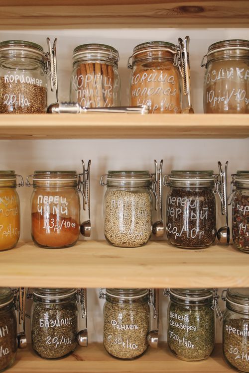 Free Rustic wooden shelves with assorted spices and ingredients stored in labeled glass jars for zero-waste storage. Stock Photo