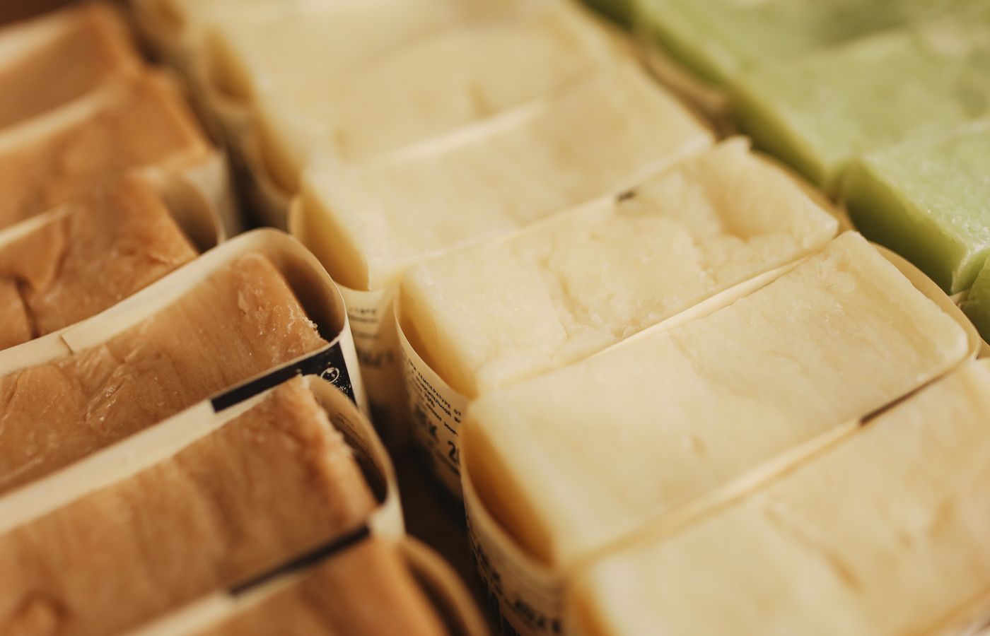 A variety of handmade natural bar soaps displayed in an organized manner, perfect for skincare and eco-friendly beauty products.
