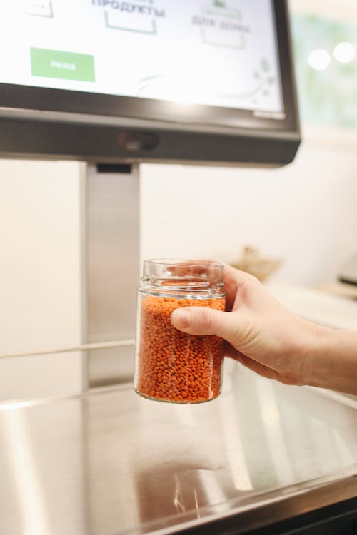 Free Person Holding Clear Glass Jar With Brown Substance Stock Photo