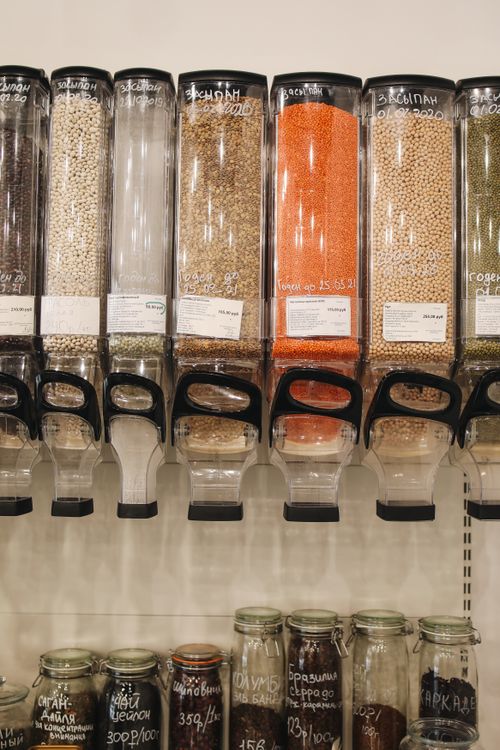 Free Bulk food dispensers with grains in a zero waste store promoting sustainable shopping. Stock Photo