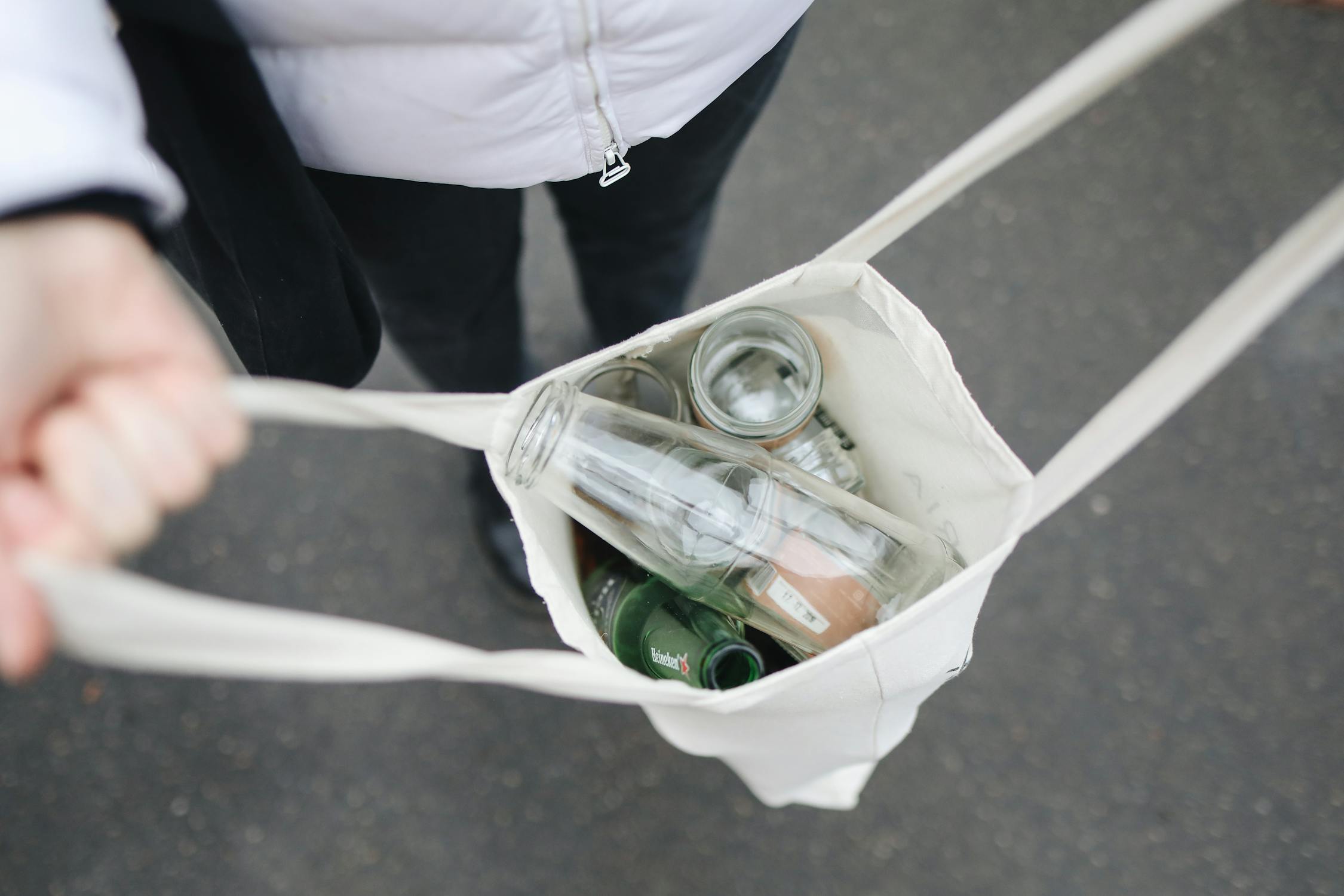 a bag with plastic and glass bottles