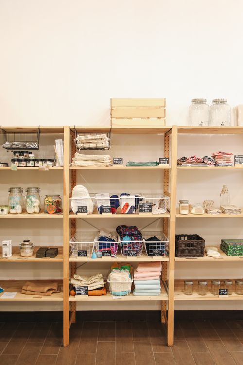 Free A wooden shelf display showcasing eco-friendly products in a zero waste store. Stock Photo