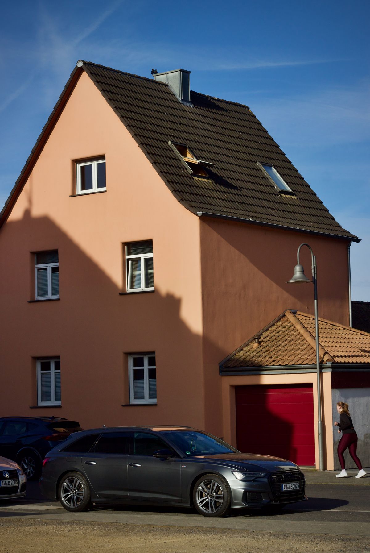suburban house with modern car and street lamp