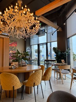 Cozy café interior featuring a crystal chandelier and modern seating.