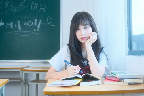 Free A young female student writing in a notebook inside a classroom in Vietnam. Stock Photo