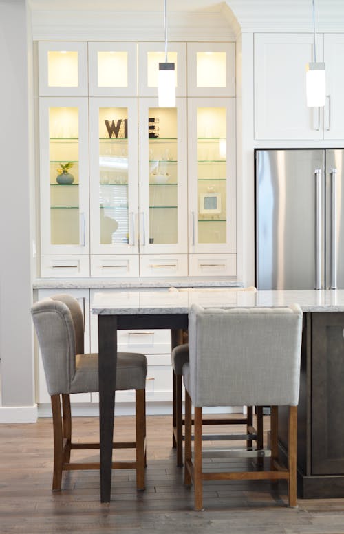 Two Grays on Floor Beside Table