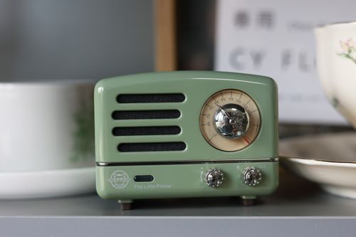 Free A vintage-style green radio placed on a shelf with elegant ceramic cups, adding a nostalgic touch to home decor. Stock Photo