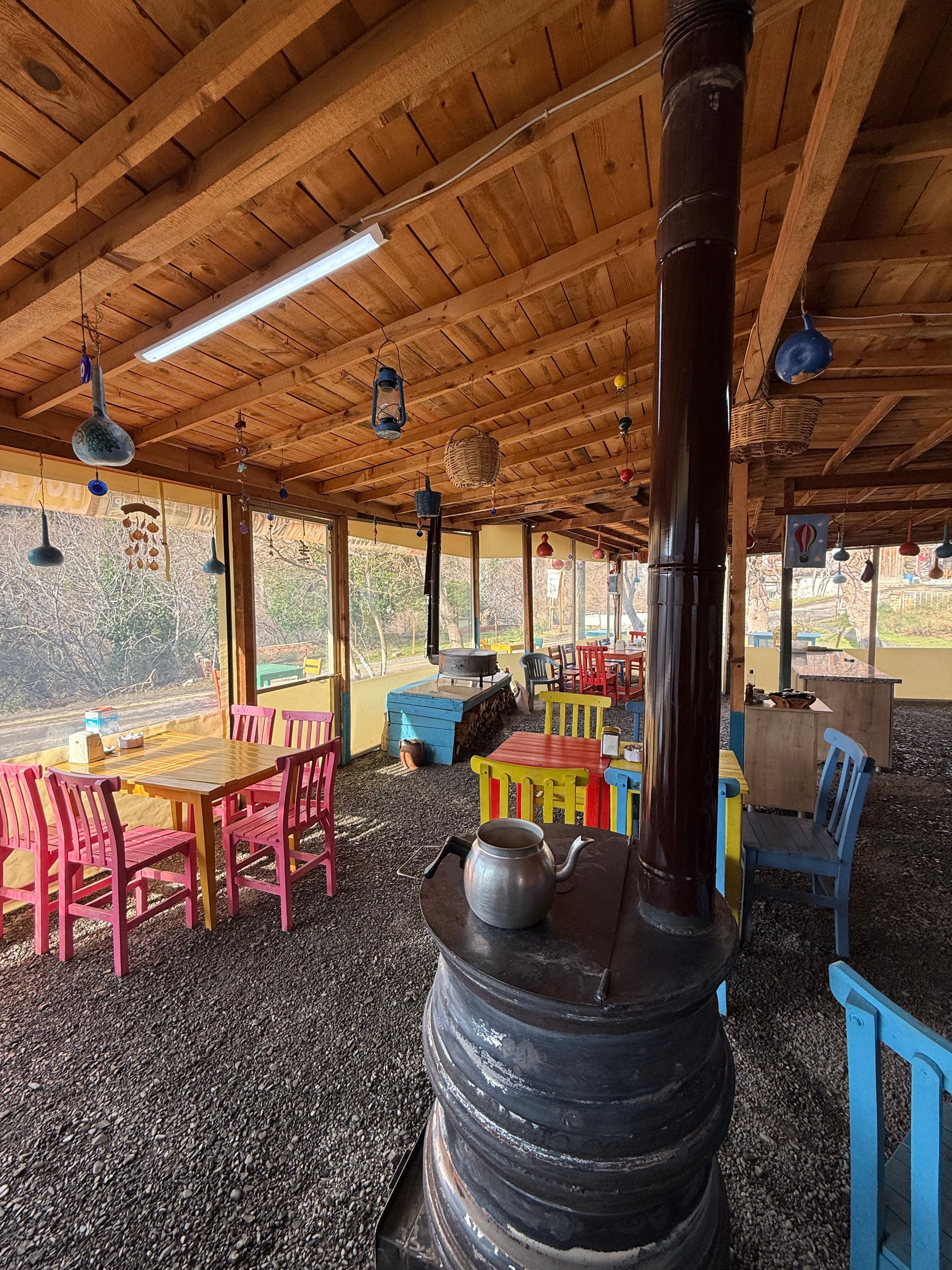 Quaint outdoor cafe in Turkey with colorful furniture and rustic charm, offering a cozy dining ambiance.