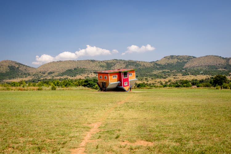 Upside Down House In Grass Field