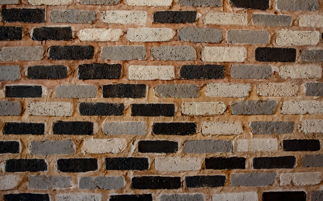 a textured brick wall showcasing varied patterns and tones perfect for