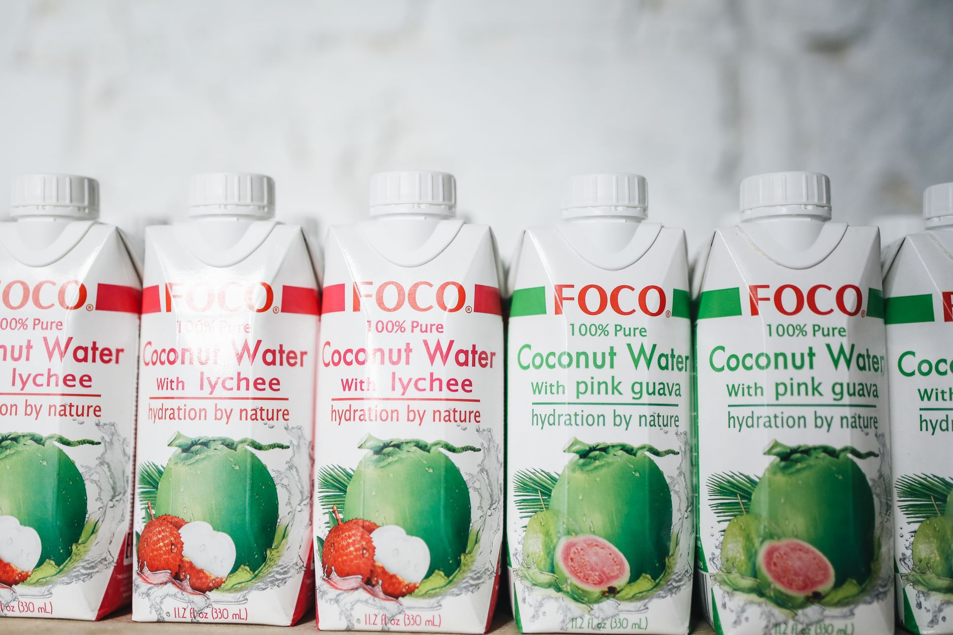 Assorted coconut water bottles with lychee and pink guava flavors for a refreshing taste experience.