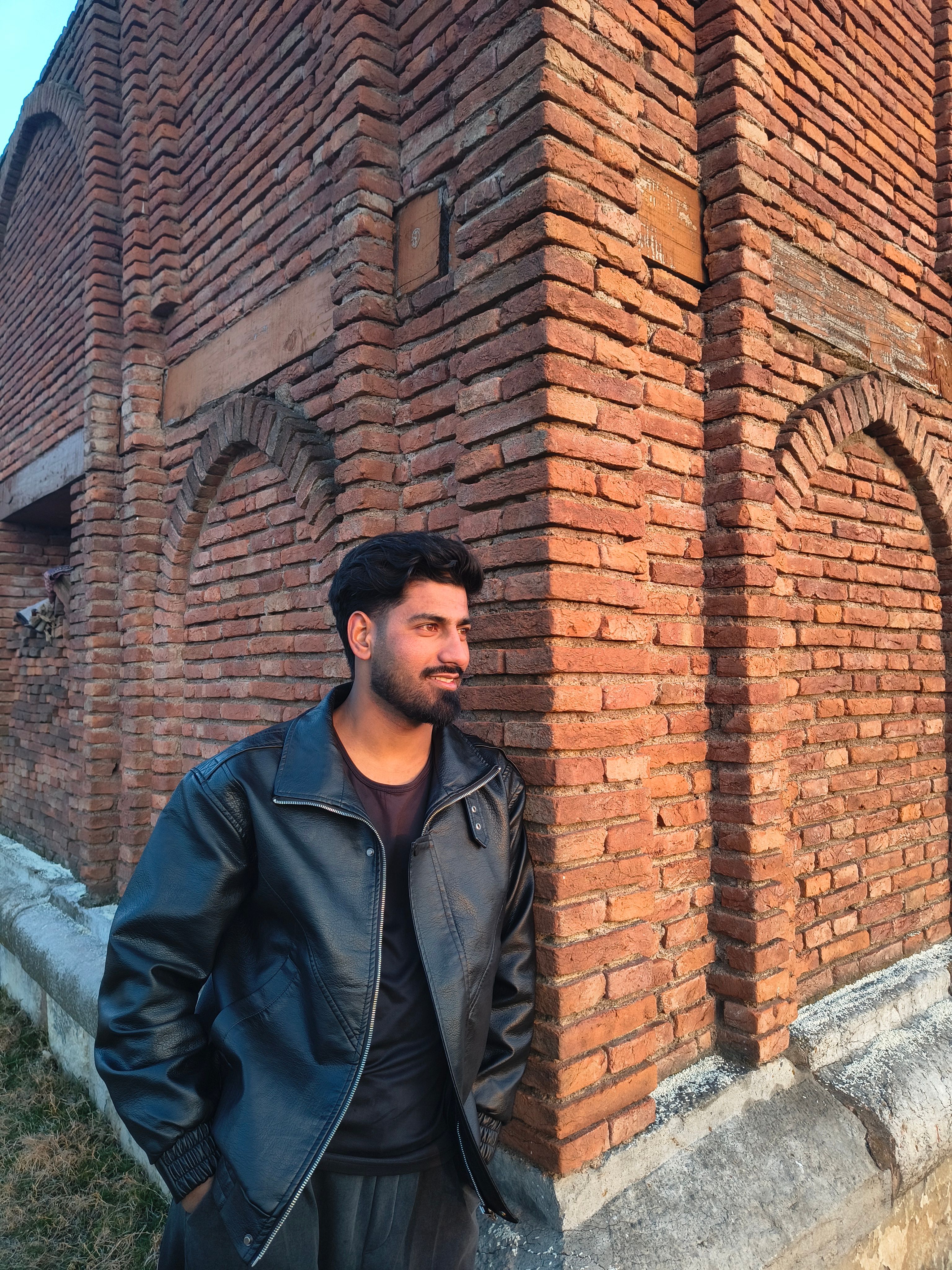Urban Portrait of Man by Historic Brick Wall · Free Stock Photo
