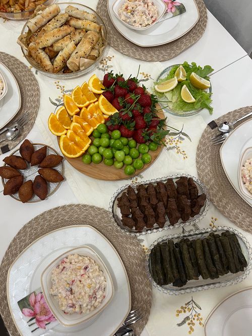 Free A delicious spread of Middle Eastern dishes, featuring vibrant fruits and savory delights, perfect for a festive occasion. Stock Photo