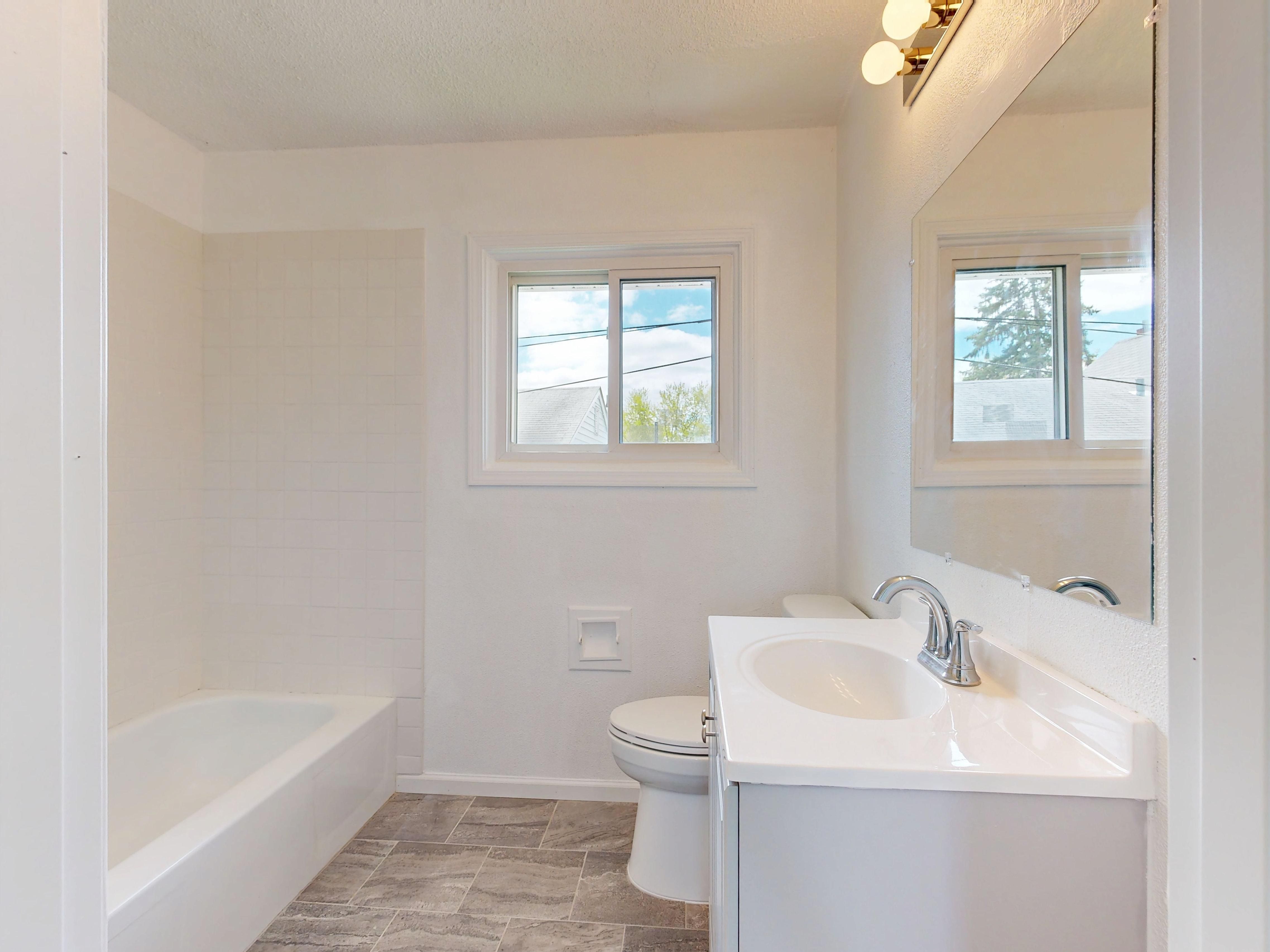 Spacious bathroom interior featuring bright lighting and contemporary design.