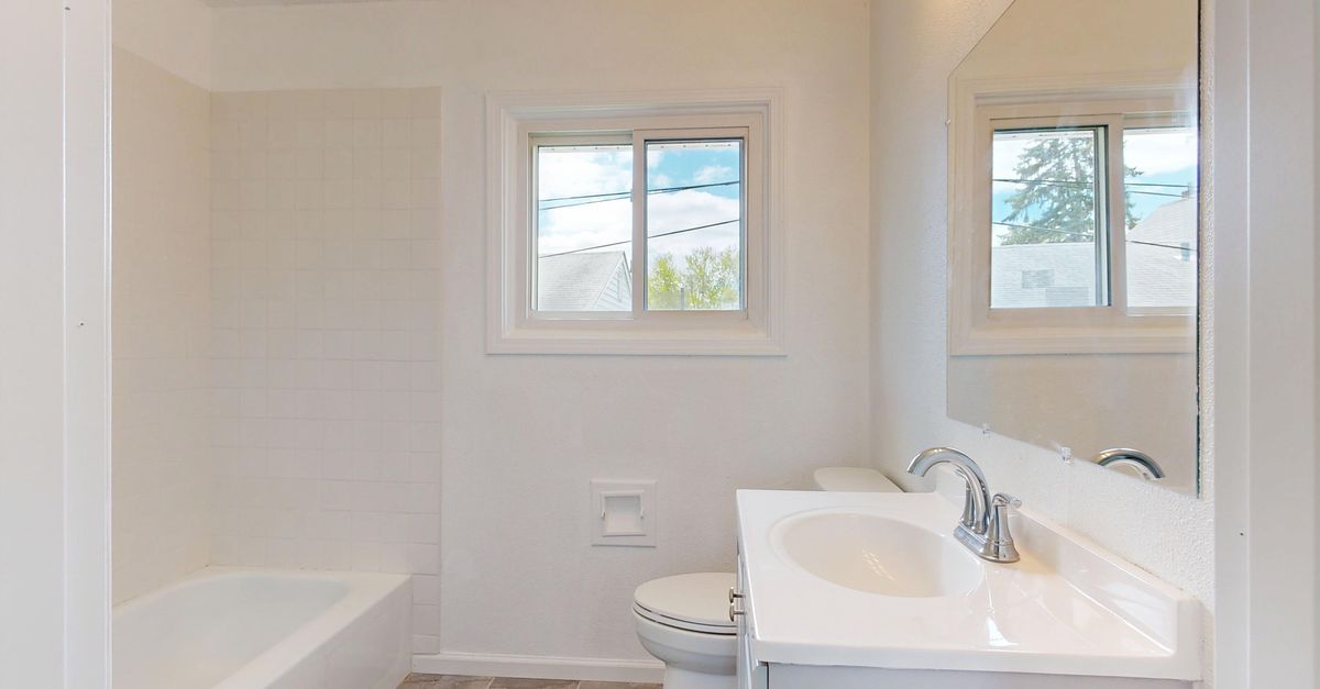 Spacious bathroom interior featuring bright lighting and contemporary design.