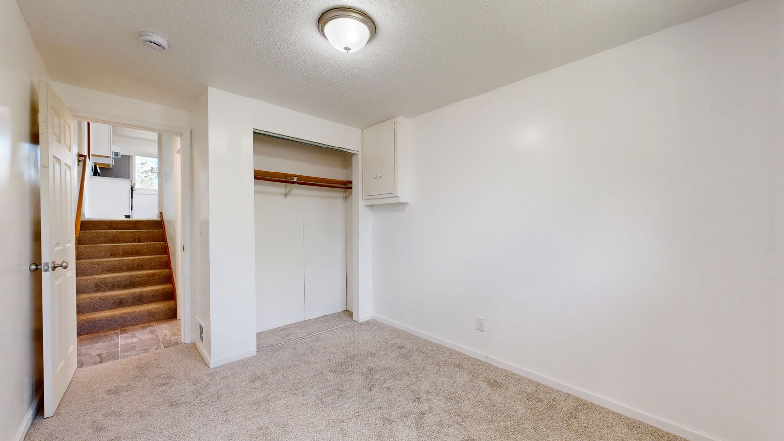 Illustrative residential carpeted room and stairs
