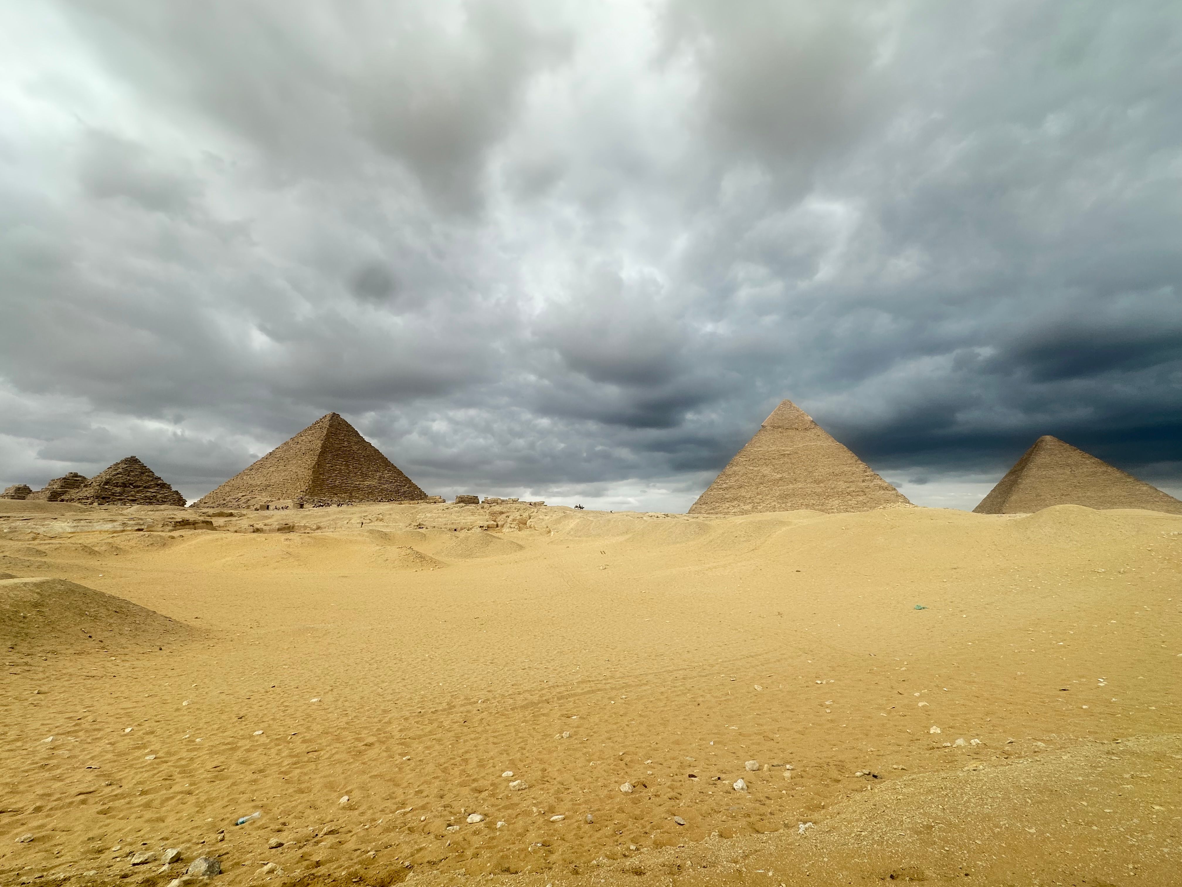 Majestic View of Giza Pyramids Under Dramatic Sky · Free Stock Photo