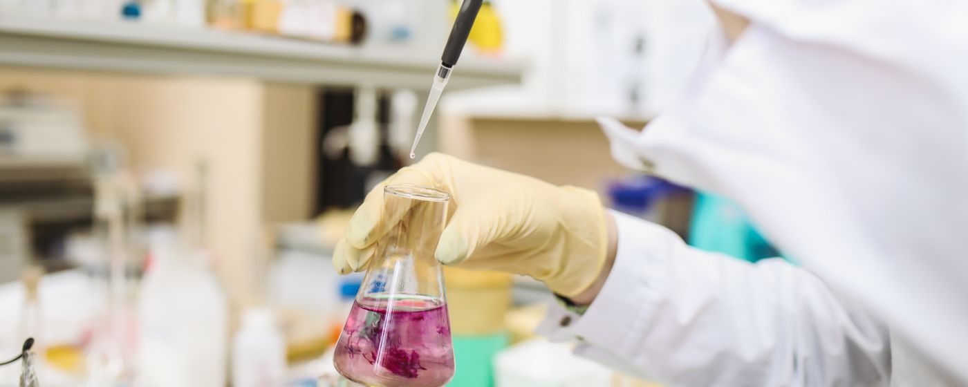 Scientist using pipette in laboratory