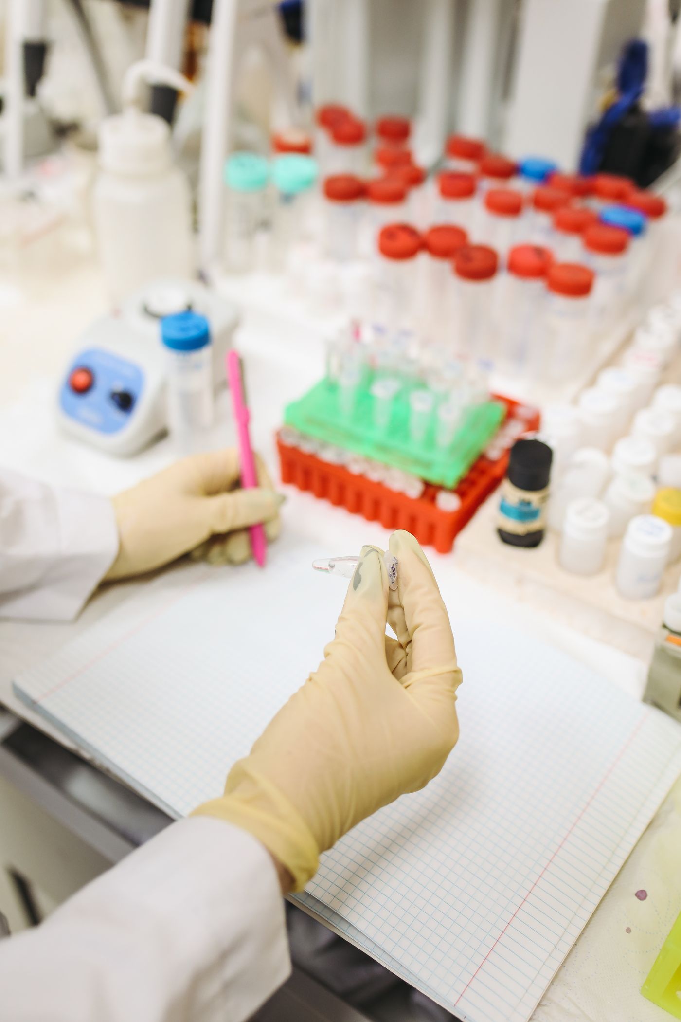 Scientist handling molecular samples and tubes in a bright targeted PCR laboratory workflow