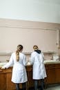 Women In White Laboratory Gown Standing In Front Of A Counter