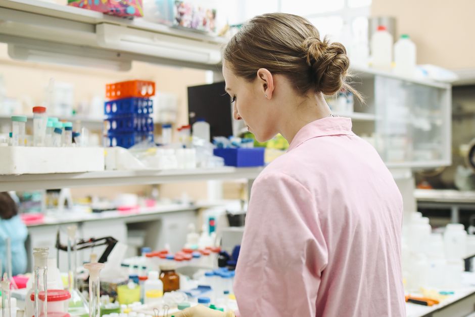 Scientist working at a laboratory bench — clinical research on ibogaine and alcohol addiction shows consistent GDNF-mediated reductions in craving across observational studies