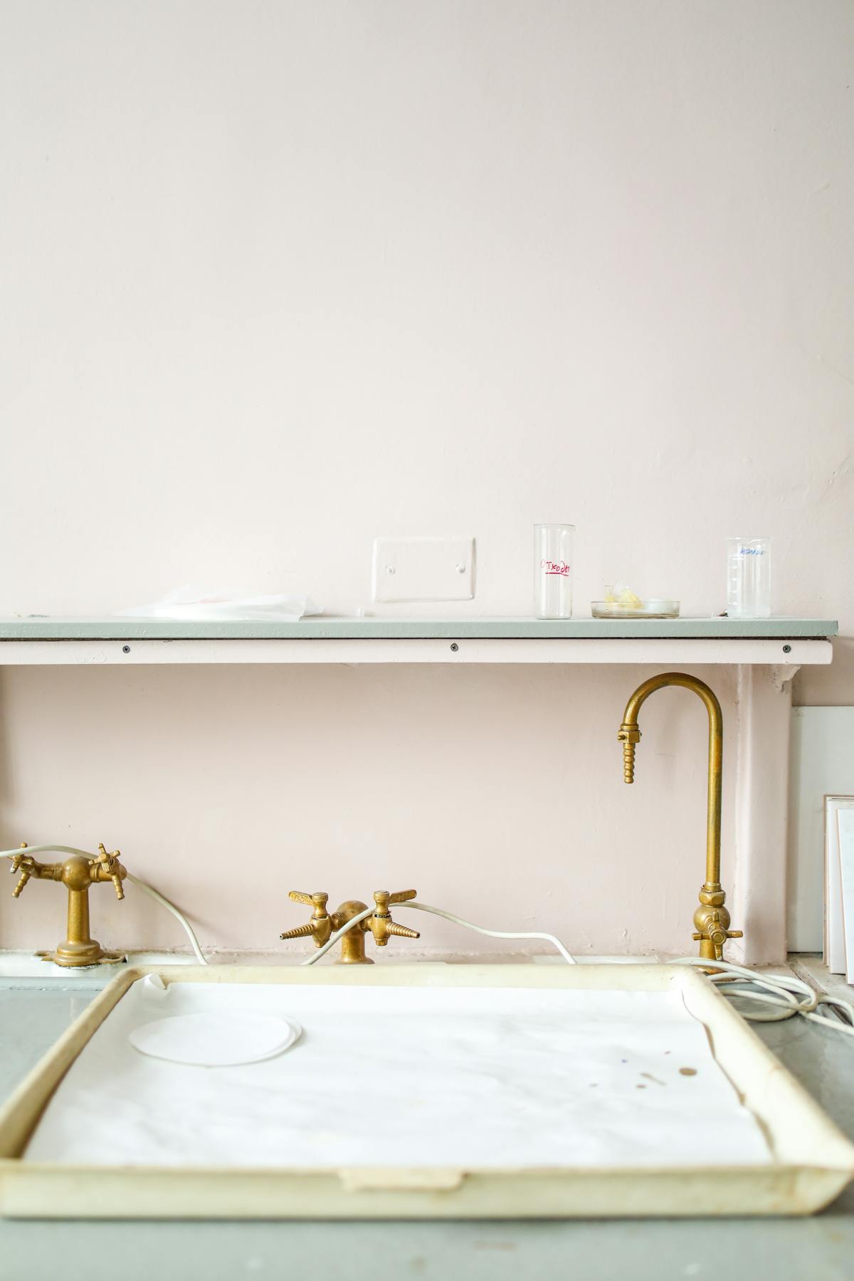 Person standing by the ocean holding a reusable water bottle