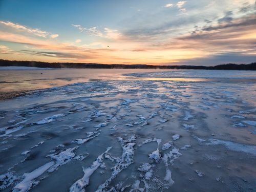 Free A serene winter sunset over a frozen lake in Reads Landing, Minnesota. Stock Photo