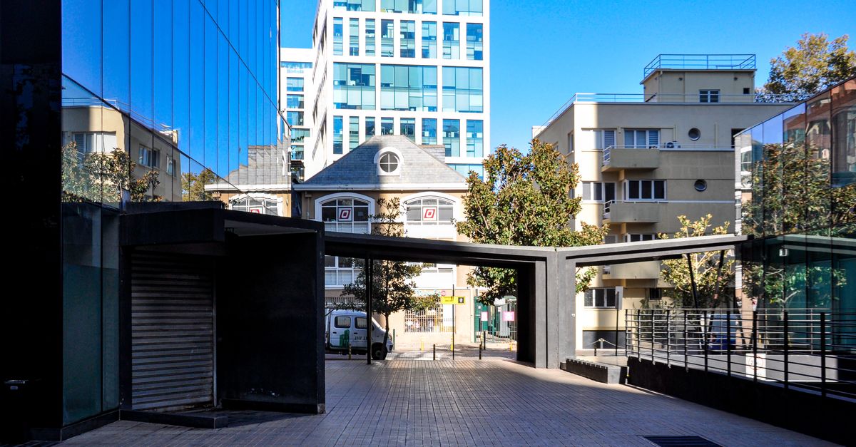Contemporary buildings and urban landscape in Santiago, Chile, under clear blue skies.