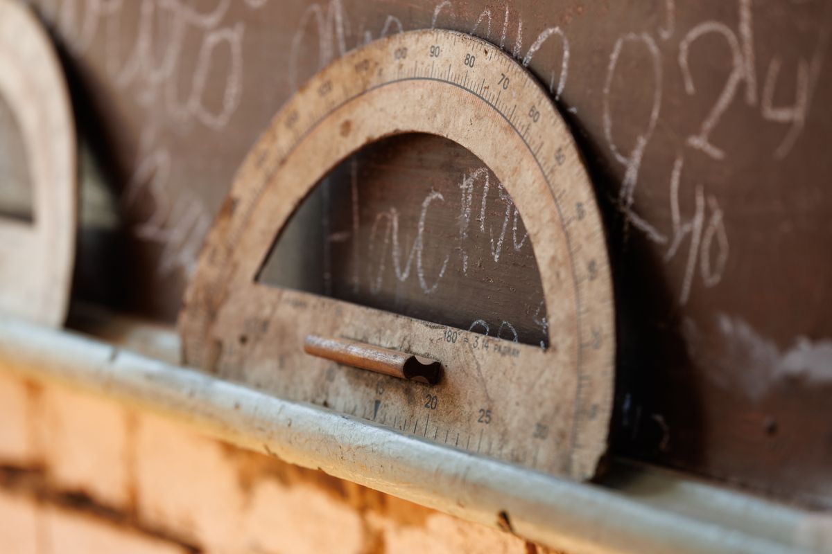 Vintage school chalkboard with large wooden geometric protractor