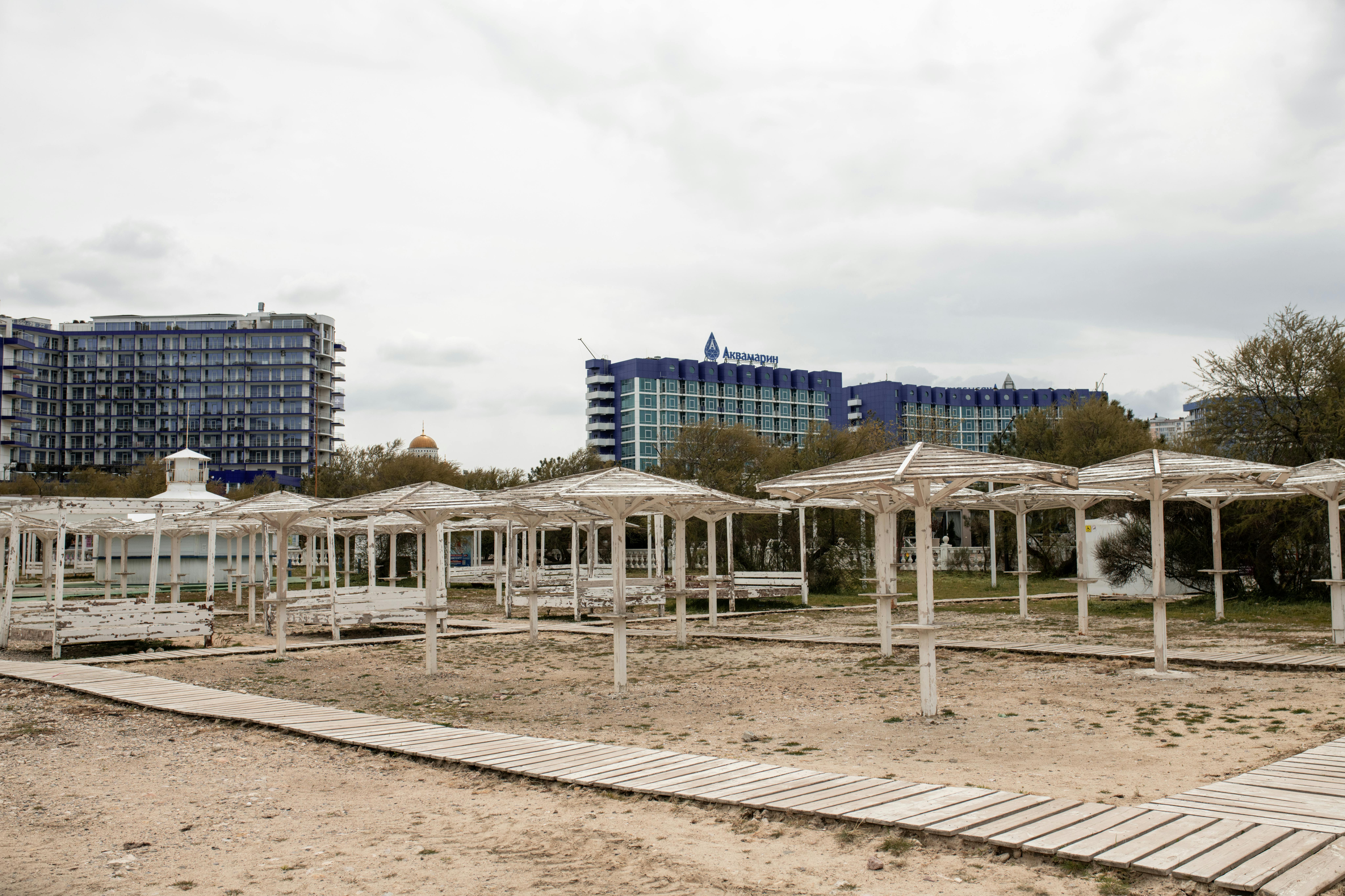 Deserted seaside resort with modern high-rise hotels in Sevastopol, under overcast skies.