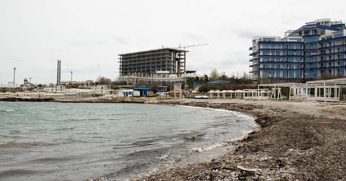 Beachfront construction site and resort buildings along the Sevastopol coastline.