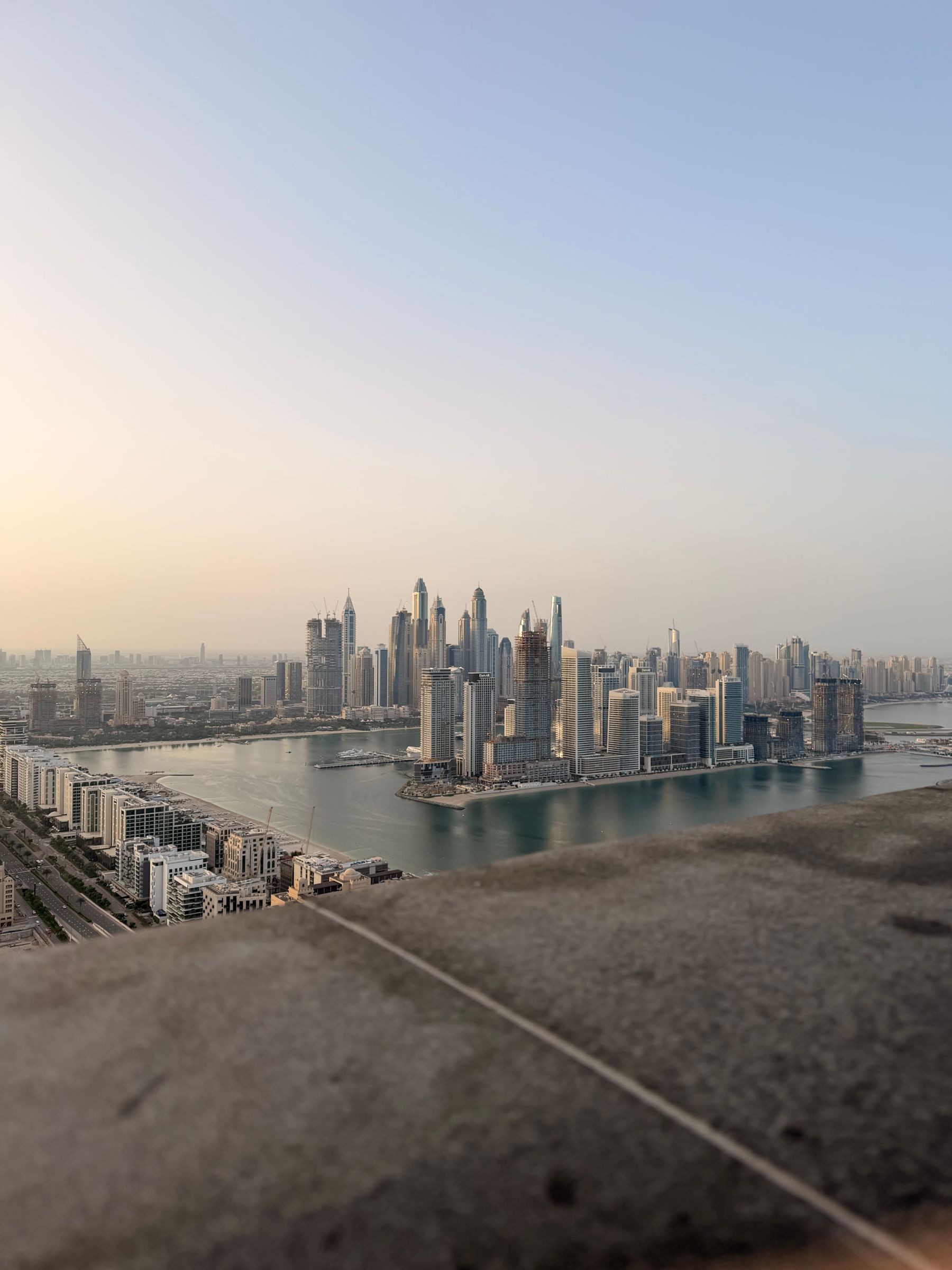 Dubai Marina skyline at sunset with waterfront and skyscrapers
