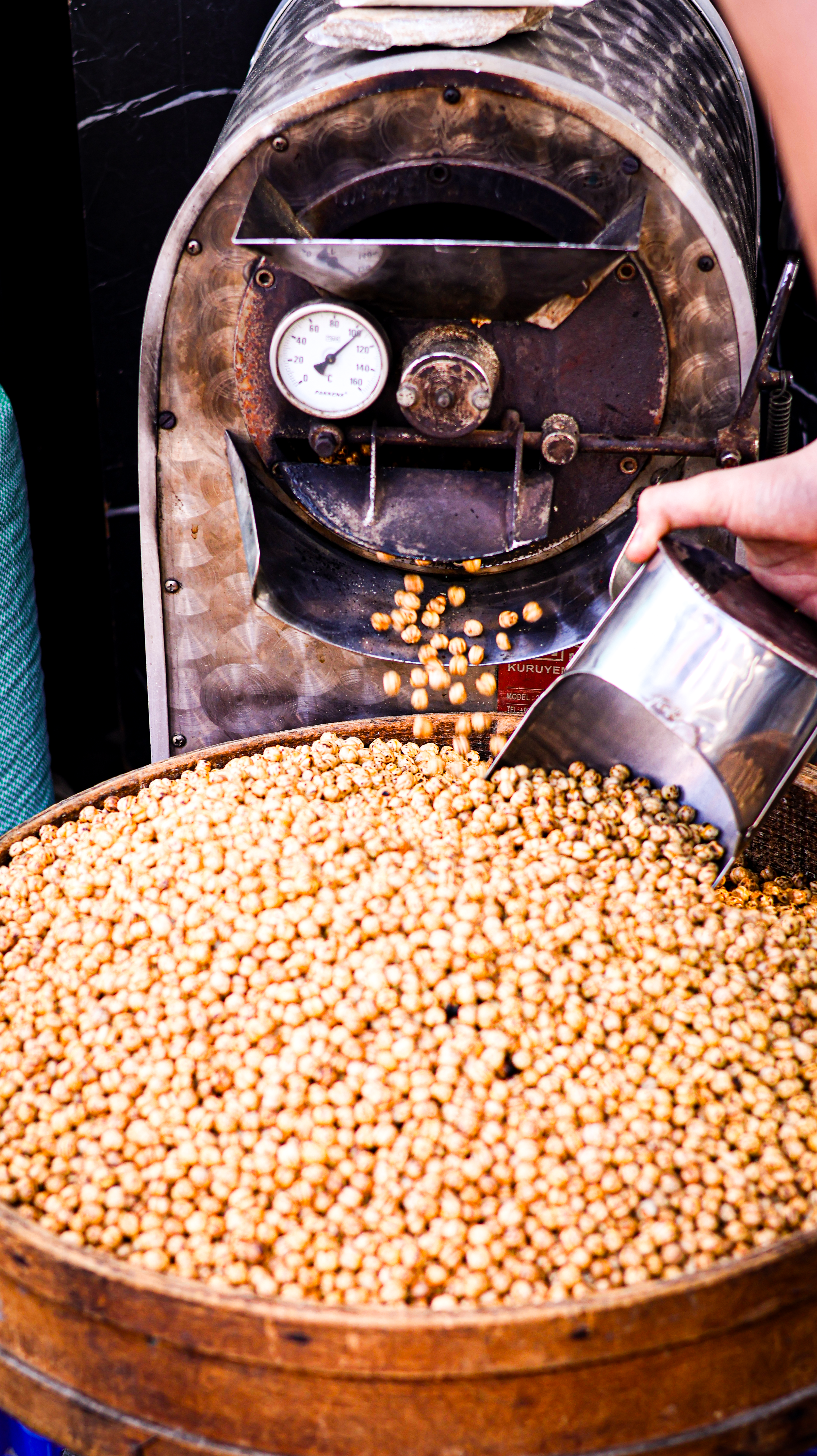 Close-up of coffee beans being roasted in an industrial machine, highlighting the process.