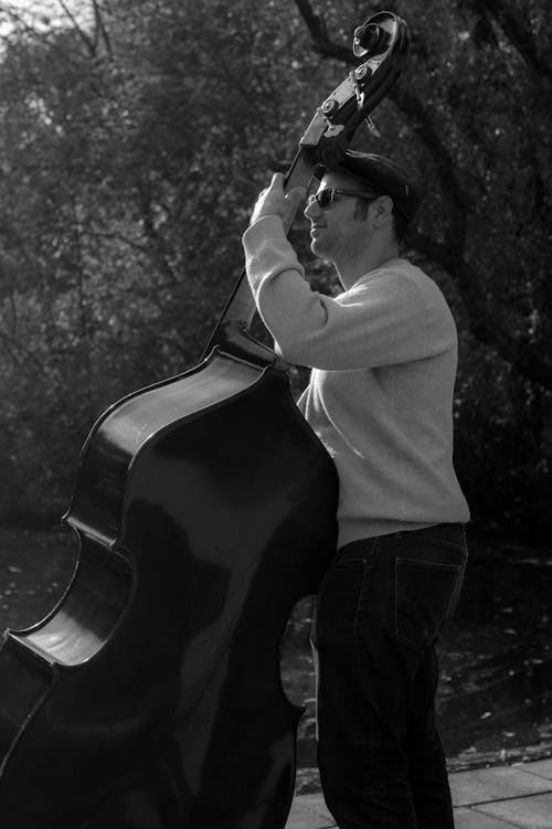 Grayscale Photography of Man Playing Cello
