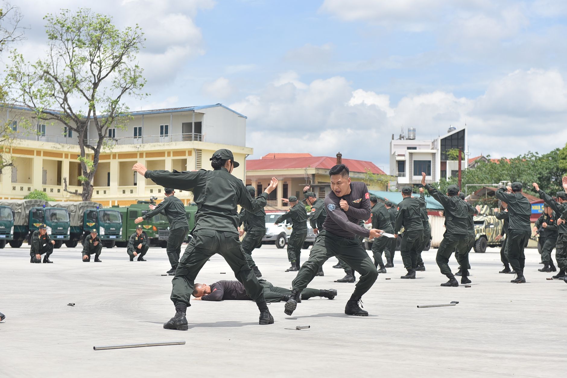 Soldiers demonstrating martial arts during an outdoor training session, showcasing discipline and skill.