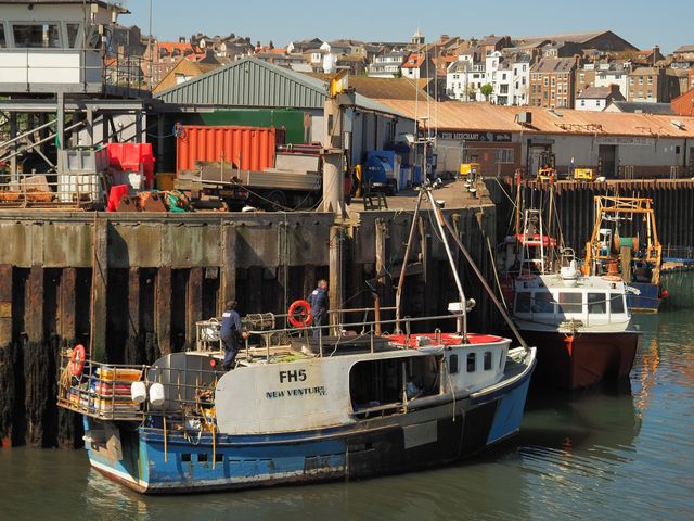 Two fishing boats docked in a coastal harbour