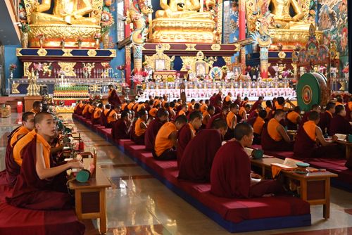 Free Monks gathered in prayer and meditation at a temple in Madikeri, Karnataka, India. Stock Photo