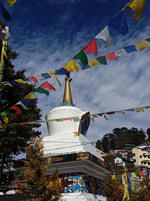 Free Scenic view of a Buddhist stupa adorned with colorful prayer flags in Mussoorie, India. Stock Photo