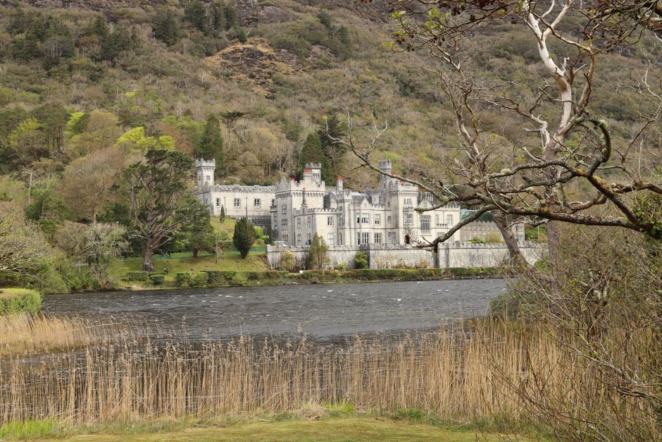 The picturesque Kylemore Abbey set against a lush, mountainous landscape near a tranquil lake. The picturesque Kylemore Abbey set against a lush, mountainous landscape near a tranquil lake.