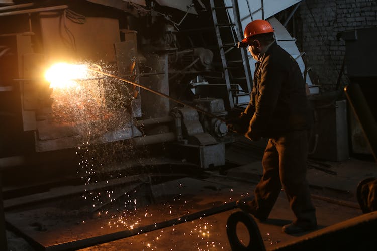 Man In Helmet Standing Near Furnace