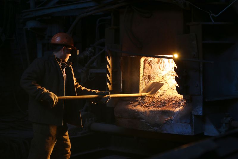 Worker operating an industrial furnace
